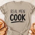 Real Men Cook T-Shirt — Sand